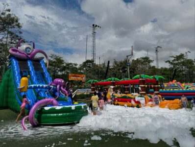 Kids playing at outdoor inflatable water slide